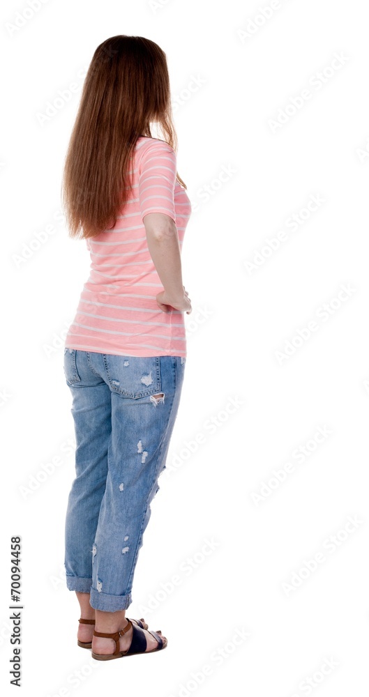Obraz premium back view of standing young beautiful redhead woman.