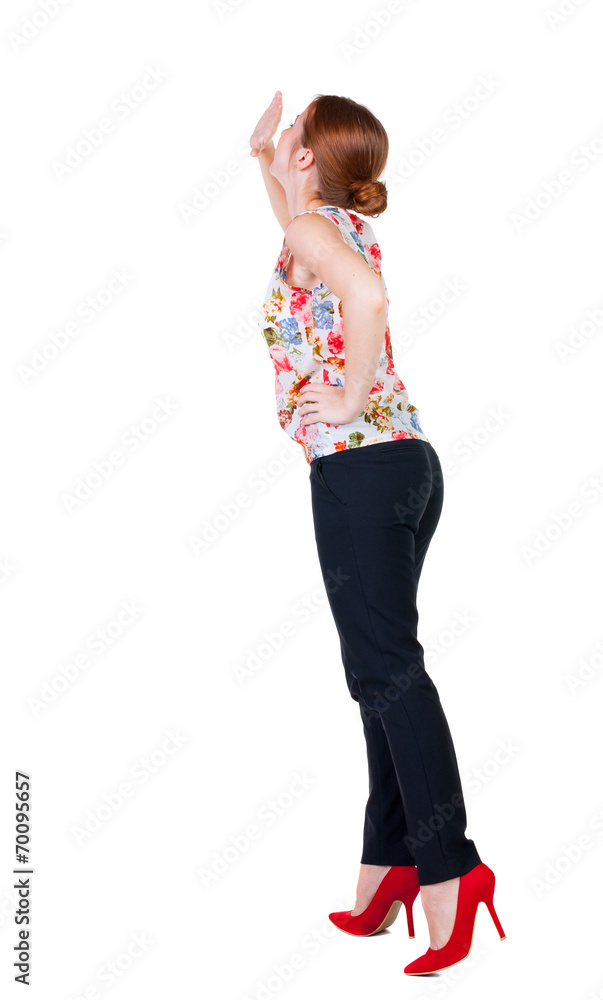 back view of woman screams with his hand to his mouth. back view of woman screams with his hand to his mouth.