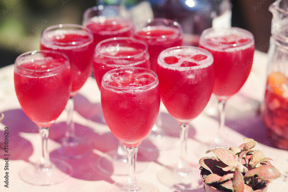 Beautiful line of different coloured cocktails on a open air par Beautiful line of different coloured cocktails on a open air par