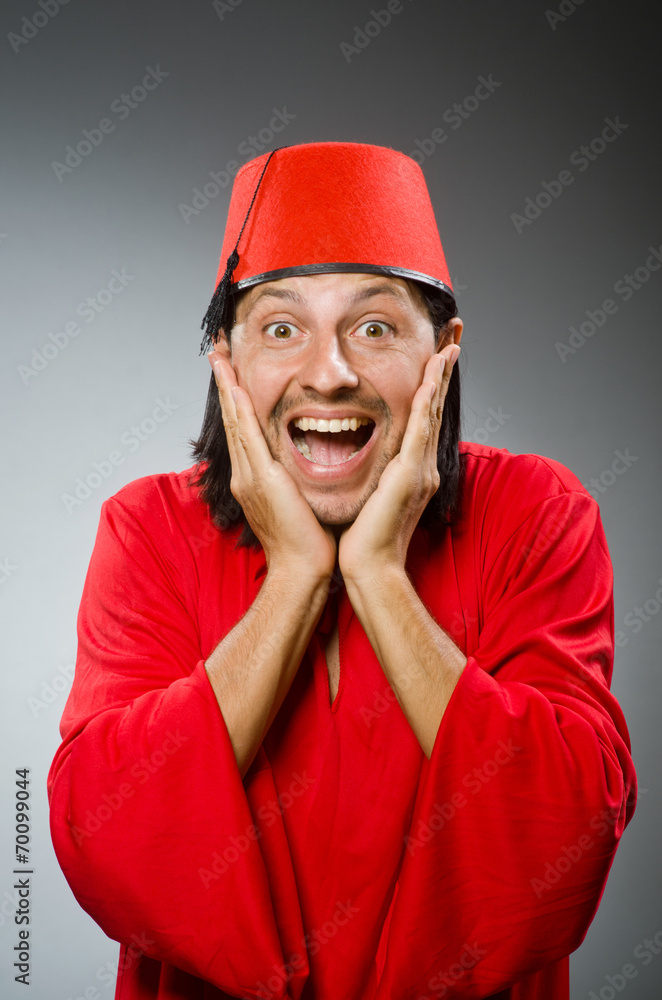 Funny man in red dress wearing fez hat Funny man in red dress wearing fez hat
