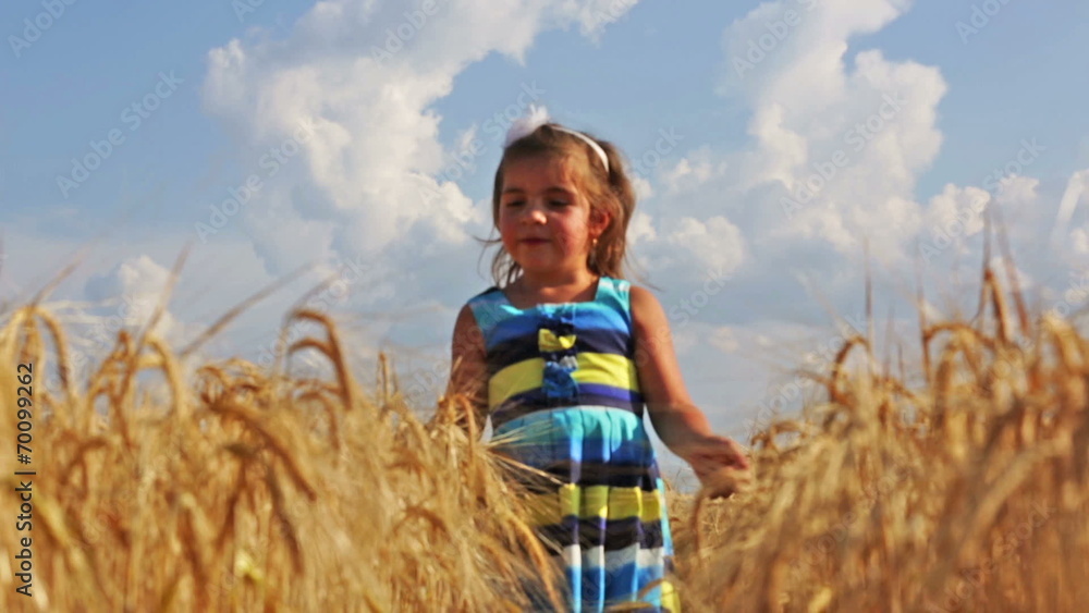 Little girl running through a wheat field Little girl running through a wheat field