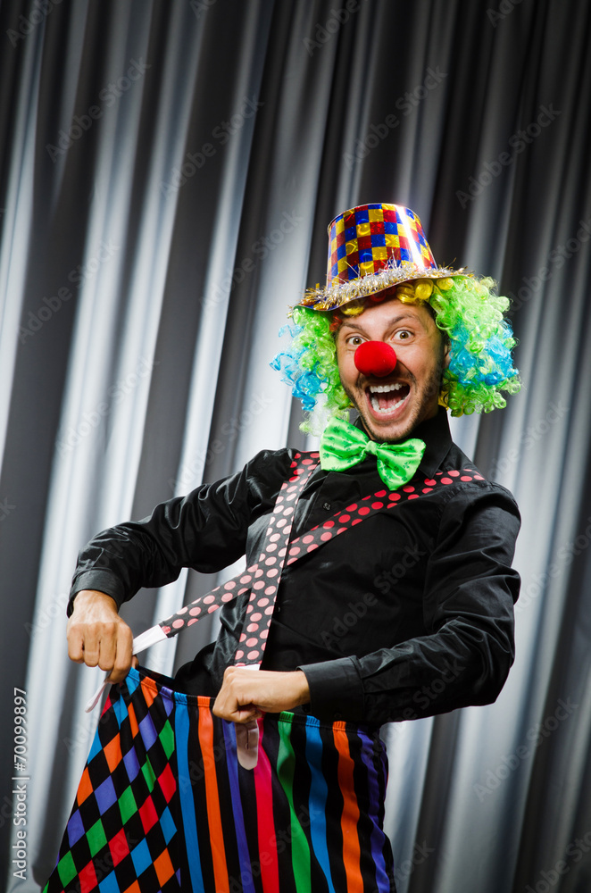  Funny clown in humorous concept against curtain