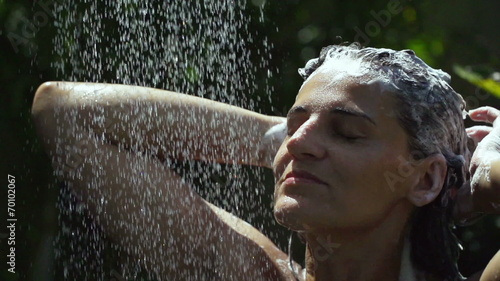 Happy woman washing her hair, slow motion shot at 240fps