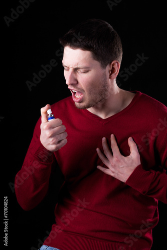 Young man using nitroglycerin photo