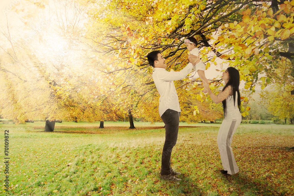 Playful family under autumn tree Playful family under autumn tree