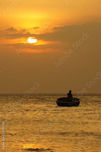 Beautiful landscape on ocean with silhouette fisherman, sun at s
