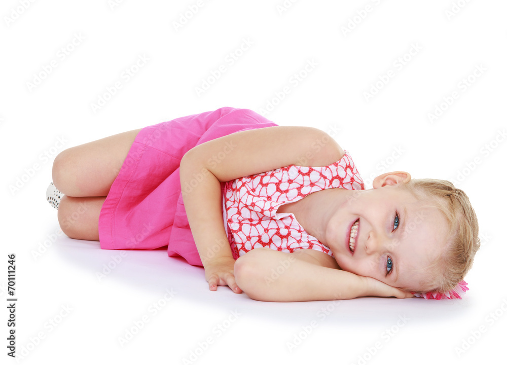 Cute little girl smiling lying on the floor Cute little girl smiling lying on the floor
