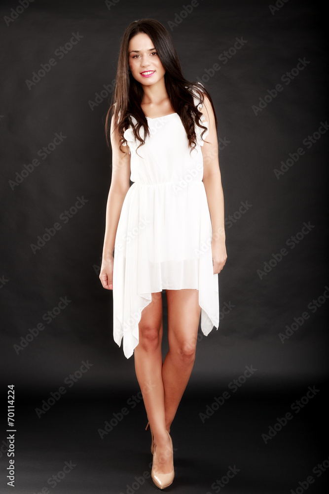 Beautiful woman in white dress on black  background