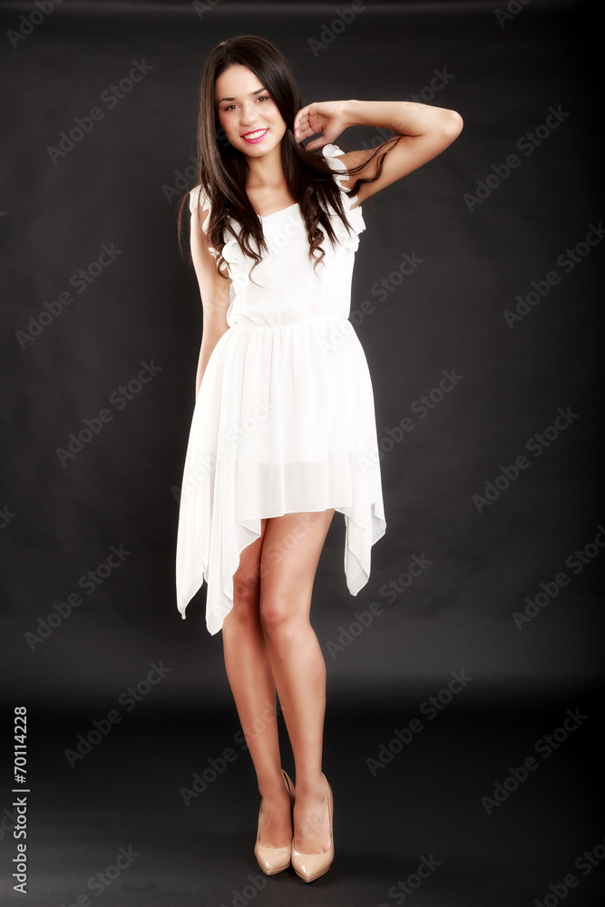 Beautiful woman in white dress on black background Beautiful woman in white dress on black background
