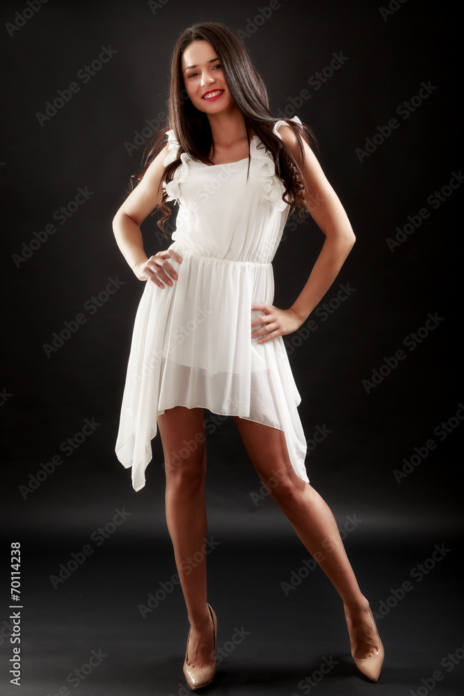 Beautiful woman in white dress on black background Beautiful woman in white dress on black background