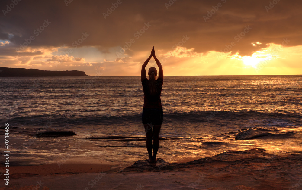 Woman Tadasana  -  Mountain Pose  yoga by the sea at sunrise