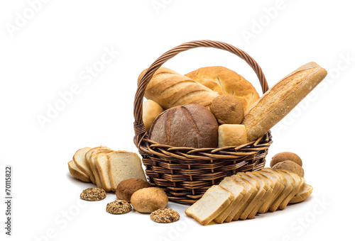 assortment of baked bread in basket on white background