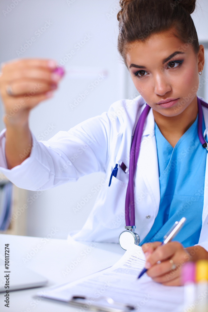 Woman researcher is surrounded by medical vials and flasks, iso Woman researcher is surrounded by medical vials and flasks, iso