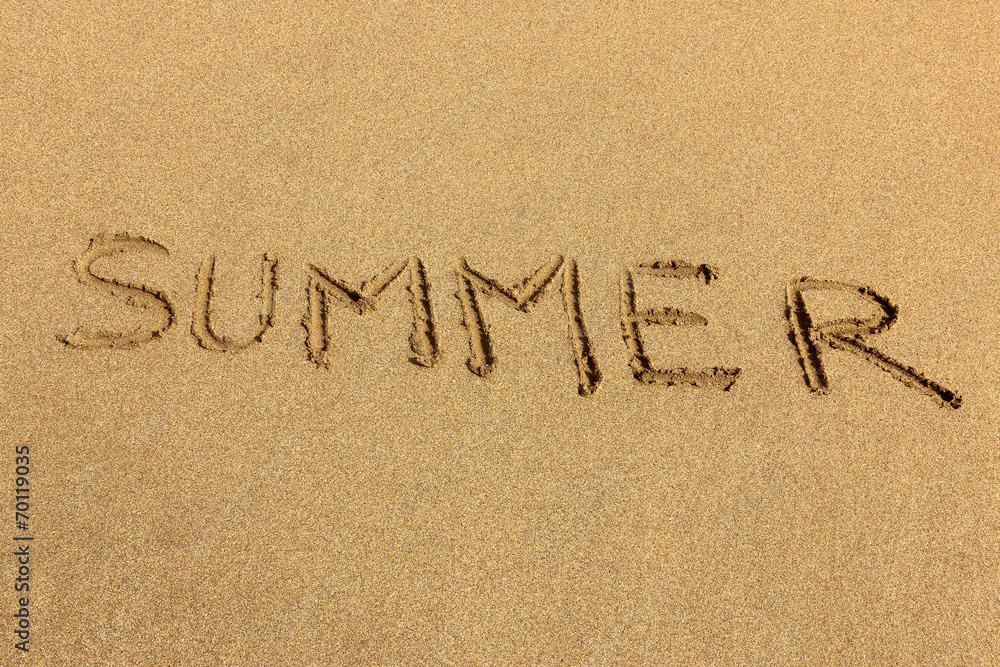 Summer - word handwritten on sand Summer - word handwritten on sand