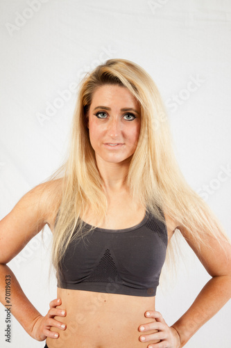 Blond woman in exercise outfit looking at the camera