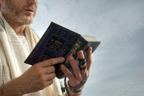 Jewish man engaged in morning prayers.