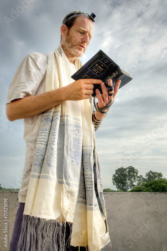 Jewish man engaged in morning prayers.