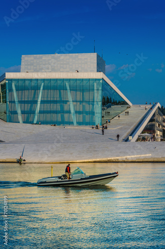 Motorboat floating in front of opera house in Oslo, Norway
