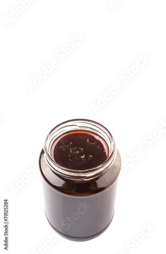 Bottled blueberry jam over white background