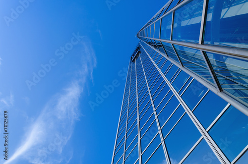 Metal blue skyscrapper's windows against clear blue sky photo