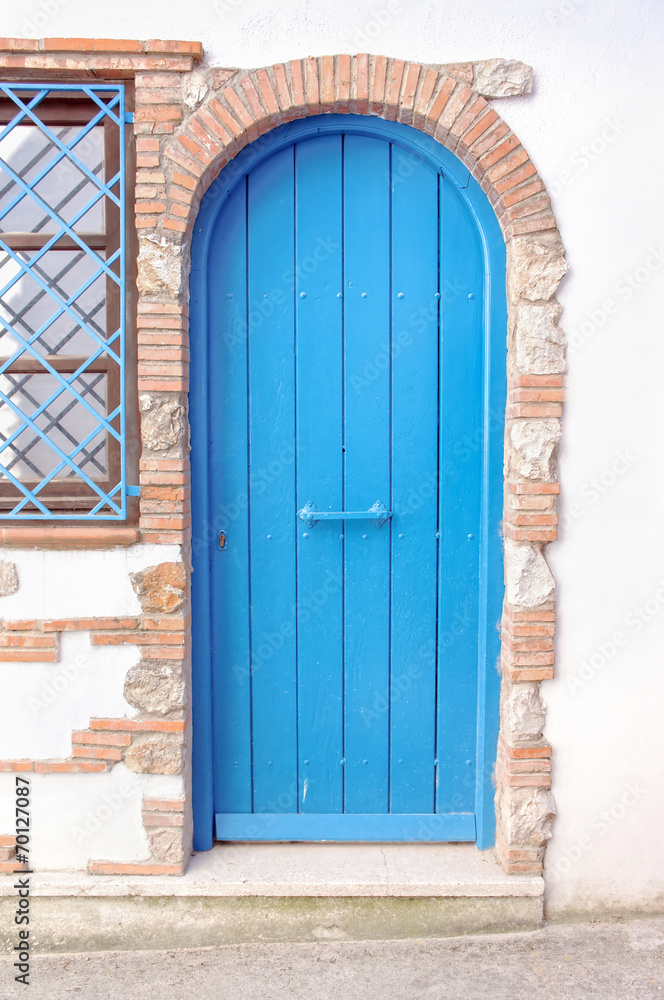 Closed blue door in a italian alley