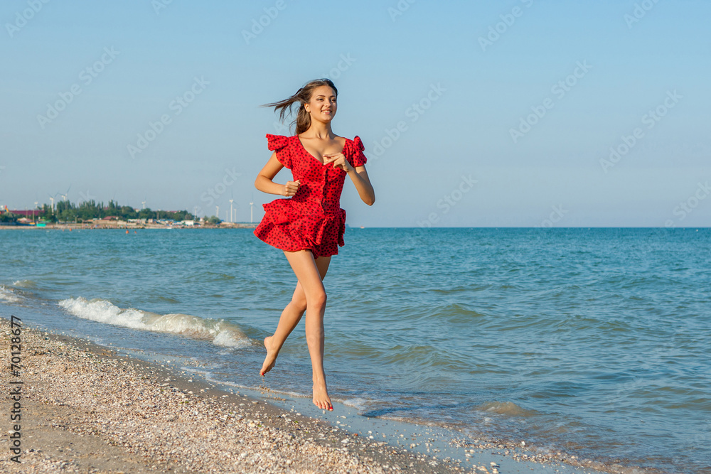 Young woman runs on the sea Young woman runs on the sea
