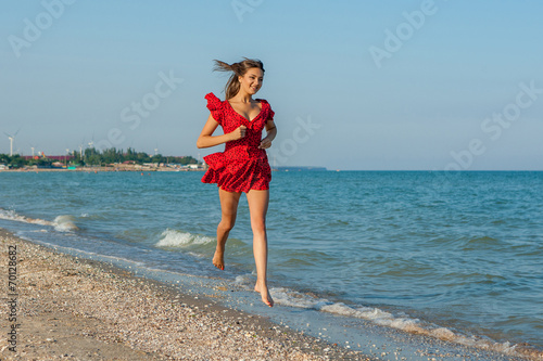 Young woman runs on the sea