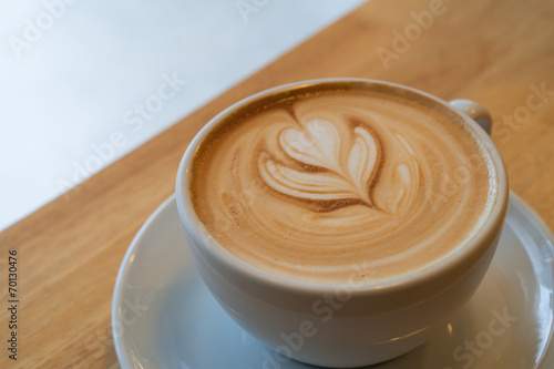 A Latte Coffee art on the wooden desk