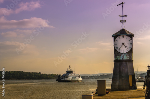 Clock tower and Oslo fjord viewed from harbor of Oslo, Norway