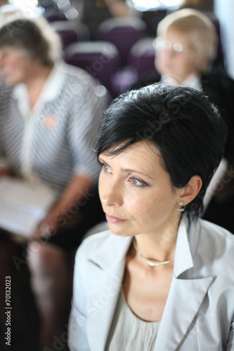 Beautiful middle-aged woman at conference