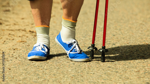 active woman senior nordic walking in park. legs