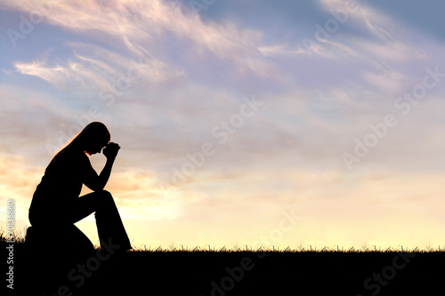 Woman Sitting Down in Prayer Silhouette