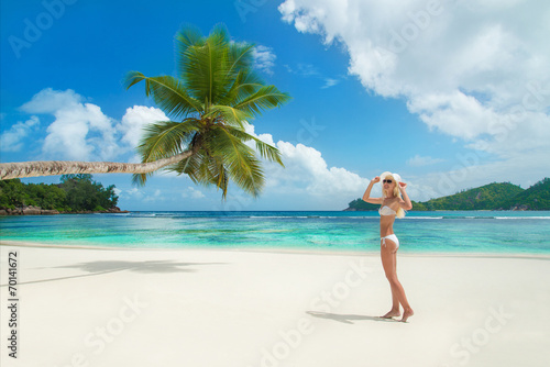 Blonde woman at beach Baie Lazare at Mahe, Seychelles