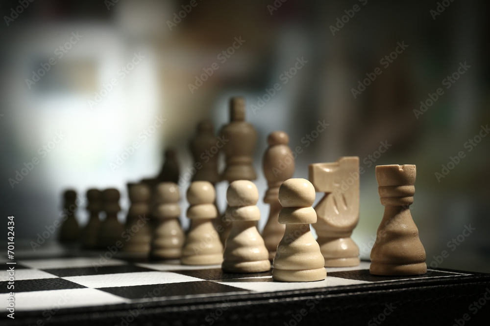 Chess board with chess pieces on dark background Chess board with chess pieces on dark background