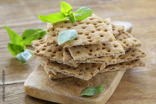 Dry flat bread crisps with herbs on a wooden board photo