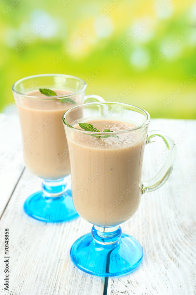 Delicious berry mousse in glasses on table on bright background Delicious berry mousse in glasses on table on bright background