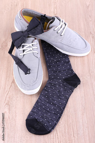 Top-siders, bow-tie and socks on wooden background photo