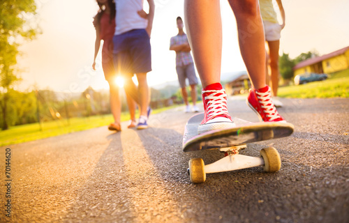 Fototapeta Naklejka Na Ścianę i Meble -  Young peoples legs with skateboard