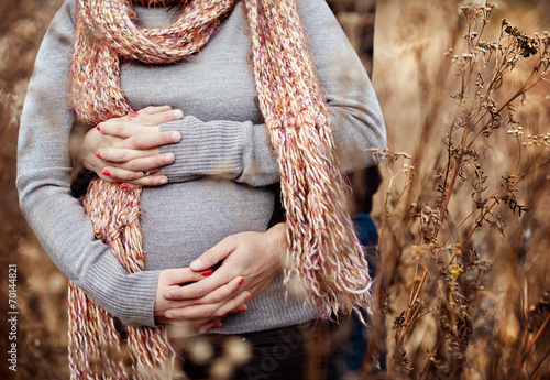 Close up of pregnant couple in autumn photo