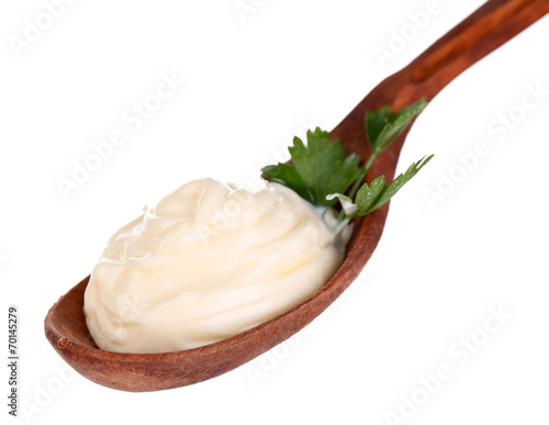 Mayonnaise in wooden spoon isolated on white