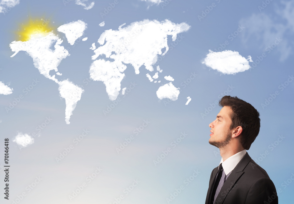 Businessman looking at world clouds and sun on blue sky Businessman looking at world clouds and sun on blue sky