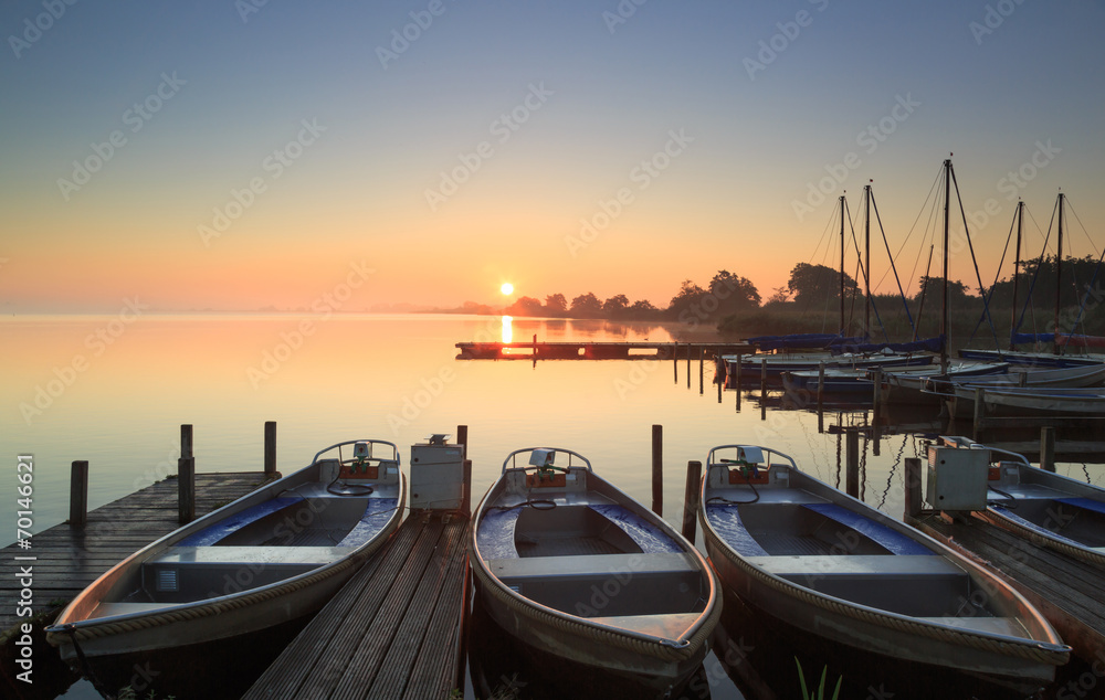 Foggy and tranquil sunrise at a small marina.