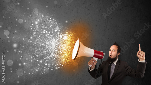 Guy shouting into megaphone and glowing energy particles explode