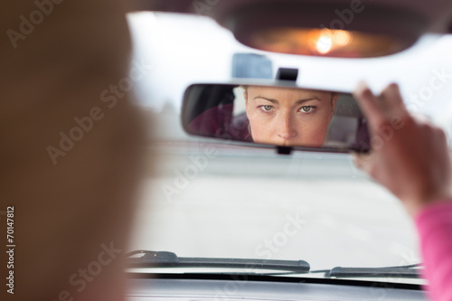 Lady looking back while reversing. photo