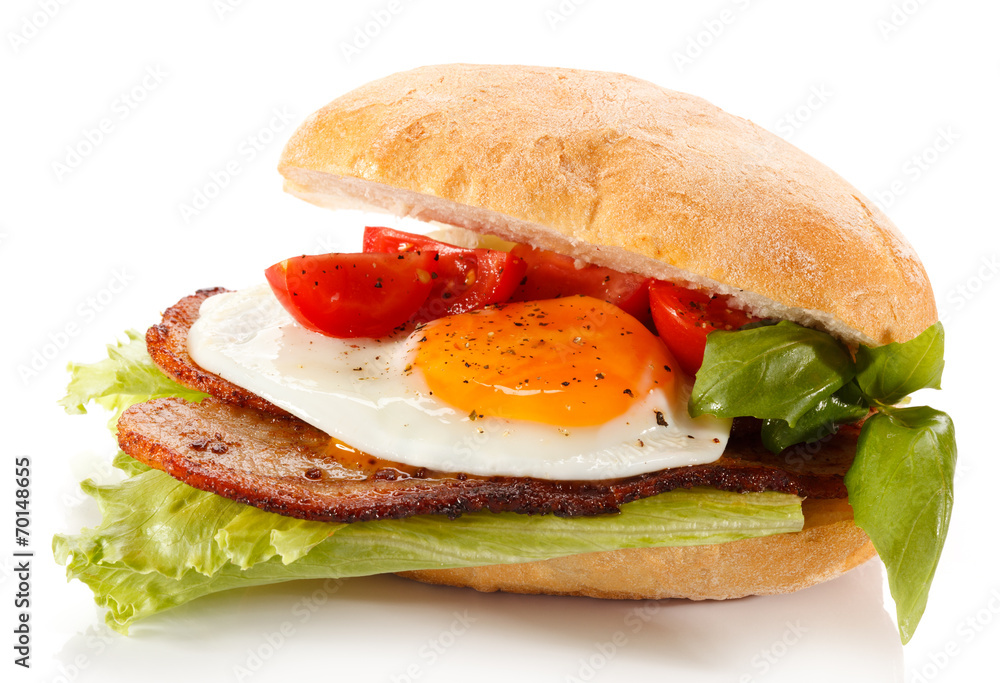 Breakfast - breadroll, fried egg, bacon and vegetables Breakfast - breadroll, fried egg, bacon and vegetables