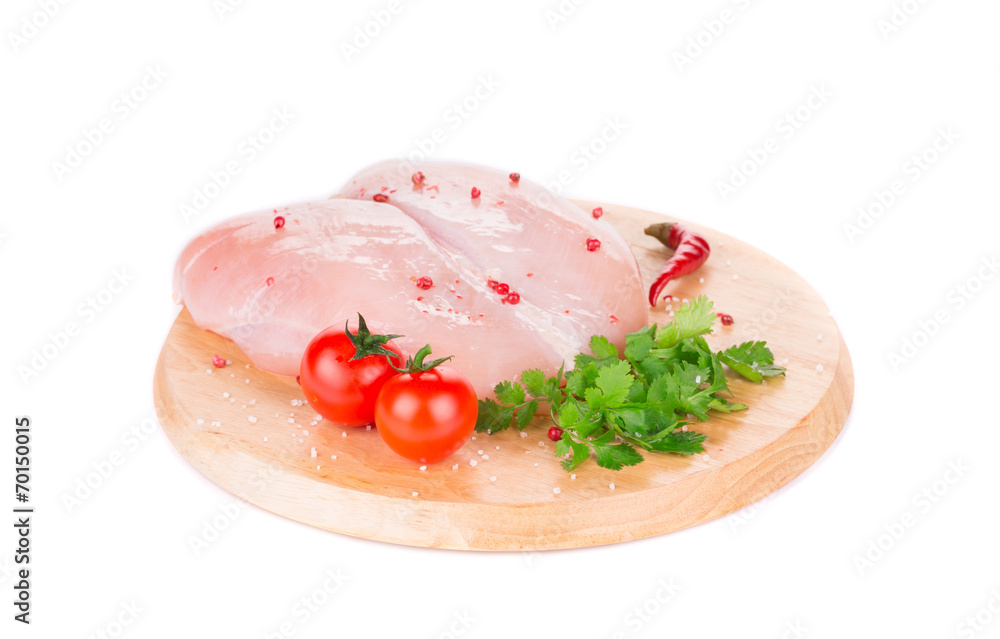 Raw chicken fillet on platter.