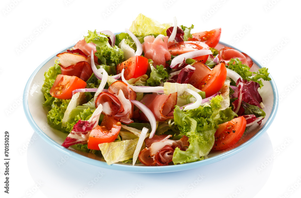 Vegetable salad with ham on white background