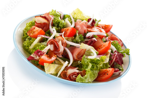 Vegetable salad with ham on white background