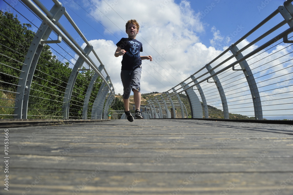 Boy running on the bridge