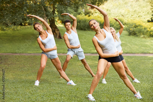 Fitness class. Portrait of smiling people doing fitness exercise
